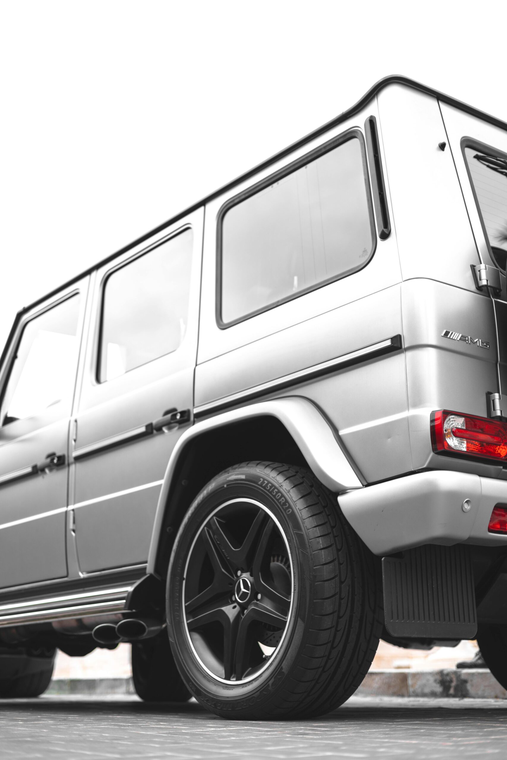 Close-up rear view of a silver SUV in urban setting showcasing elegant design.